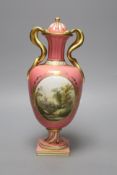 A Coalport pink ground vase and cover, with serpent handle painted with a landscape c.1825, height