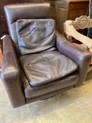 An Italian brown leather swivel armchair and two cushions, width 78cm, depth 80cm, height 91cm