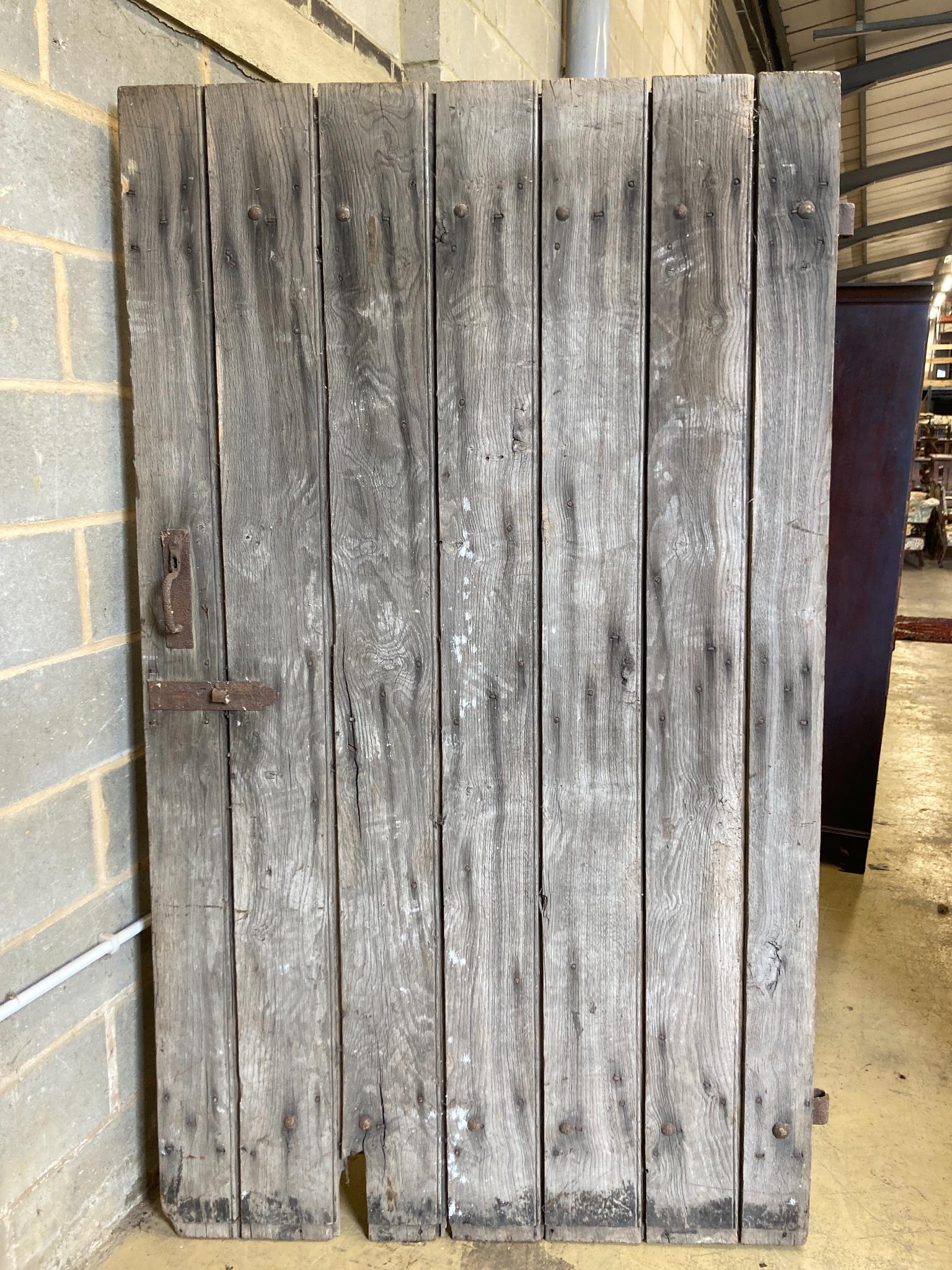 A 19th century oak barn door, width 124cm, height 213cm