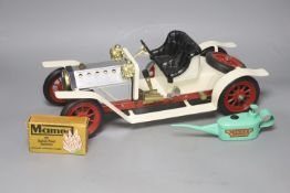 A Mamod live steam vintage two-seater roadster, with silver and cream paintwork and red wheels, oil