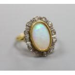 An 18ct, white opal and illusion set diamond oval cluster ring (one diamond missing),size P/Q,