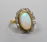 An 18ct, white opal and illusion set diamond oval cluster ring (one diamond missing),size P/Q,