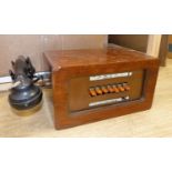 A vintage walnut-cased telephone switchboard with black Bakelite handset