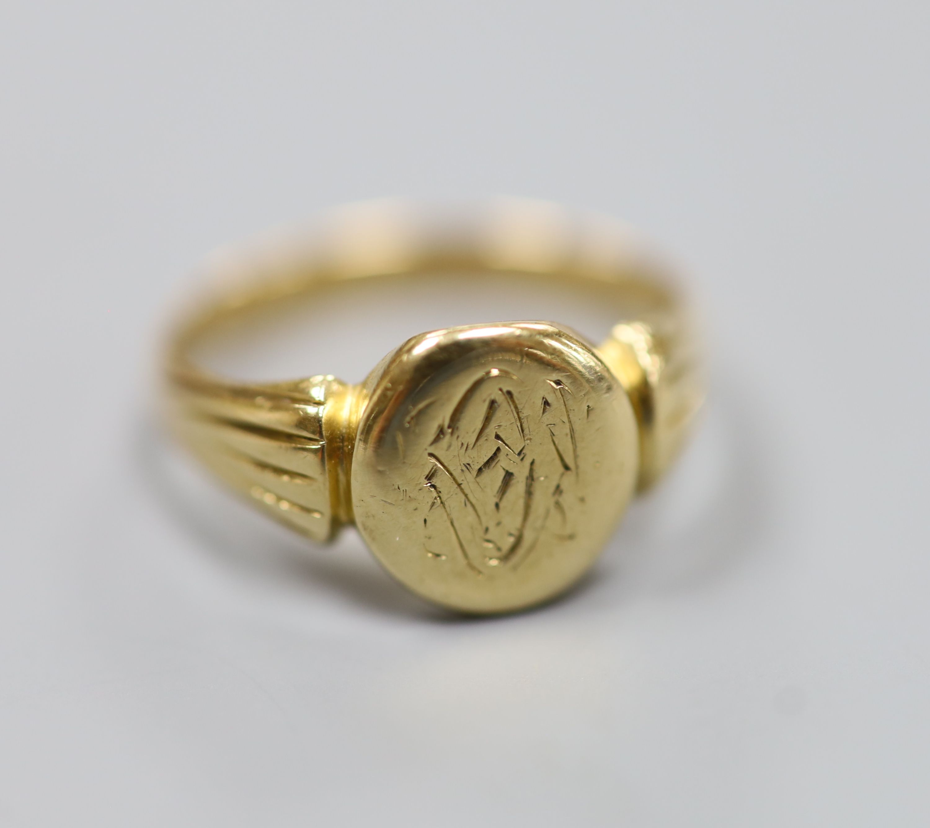 A late Victorian 18ct gold signet ring with engraved crest? (tired), size L/M,4.8 grams.