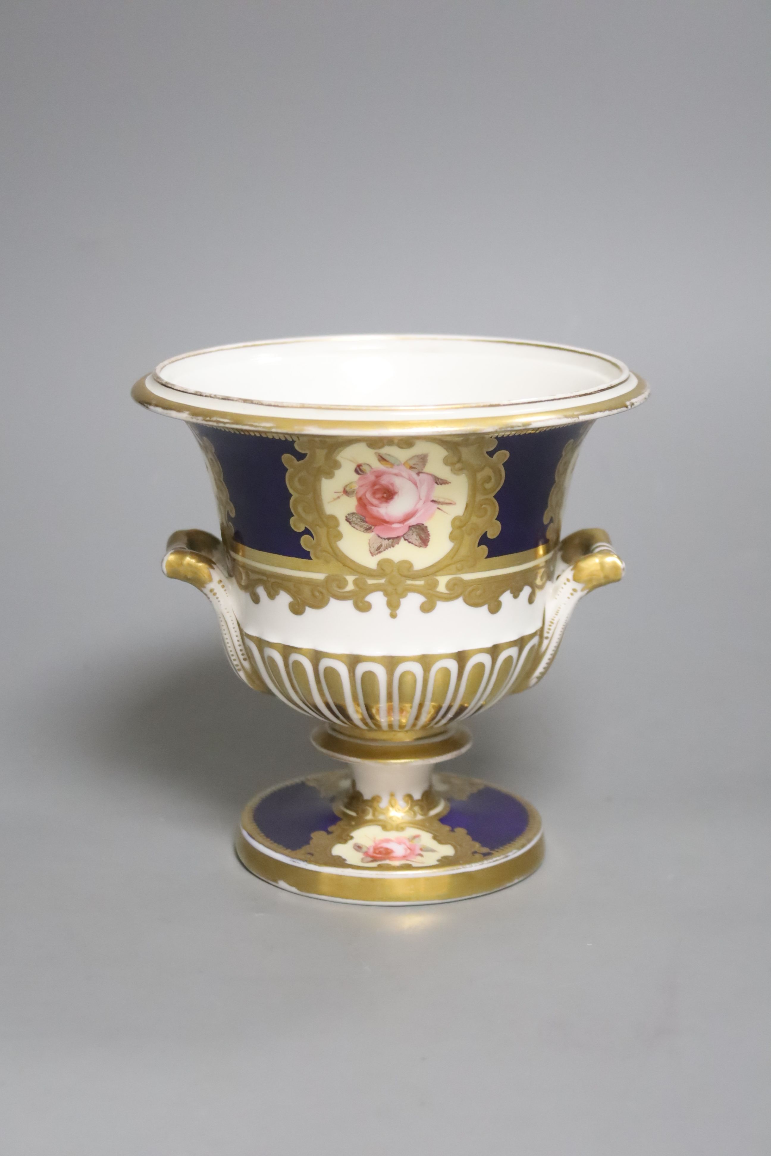 A Chamberlains Worcester two handled vase, painted with six single roses on a blue ground, height