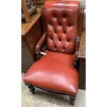 A Victorian mahogany easy chair, upholstered in buttoned red hide,with moulded frame and turned