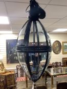 A contemporary black metal and glass hall lantern, height approx. 90cm
