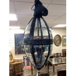 A contemporary black metal and glass hall lantern, height approx. 90cm