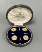 A cased set of four early 20th century 9ct and mother of pearl set buttons,gross weight 4 grams.