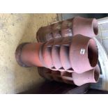 Three vintage terracotta chimney pots, largest 84cm high