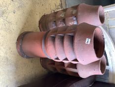 Three vintage terracotta chimney pots, largest 84cm high