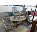 A 'Westminster' extending teak garden table, length 171cm and a set of six folding chairs