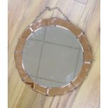 A 1930's tinted glass wall mirror, diameter 46cm