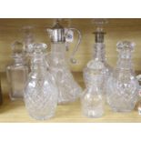 A silver mounted decanter, various other decanters, a claret jug and a jug