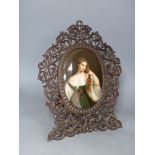 A large 19th century painted Paris porcelain plaque of a girl in a Black Forest carved frame,