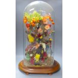 A Victorian still life display of taxidermic canaries, flowers and leaves, height 68cm