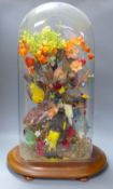 A Victorian still life display of taxidermic canaries, flowers and leaves, height 68cm