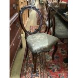 A set of four Victorian walnut balloon back dining chairs