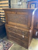 An Arts & Crafts oak escritoire, the cabinet was made out of oak shaft of the Taplow Court Mill