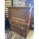 An Arts & Crafts oak escritoire, the cabinet was made out of oak shaft of the Taplow Court Mill