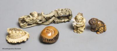 Two Japanese stag antler netsuke, a stained ivory tiger netsuke, a walrus ivory carving and a nut