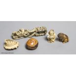 Two Japanese stag antler netsuke, a stained ivory tiger netsuke, a walrus ivory carving and a nut