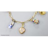 A small Edwardian 9ct gold charm bracelet, hung with eight assorted charms, approx. 16cm, gross