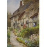Arthur Claude Strachan, (Scottish, 1865-1938), watercolour, Thatched cottage and garden, Evesham,