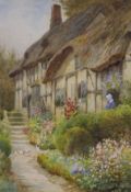 Arthur Claude Strachan, (Scottish, 1865-1938), watercolour, Thatched cottage and garden, Evesham,