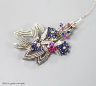 A modern white metal, ruby, sapphire and diamond set foliate spray brooch, 567mm,gross weight 11.2