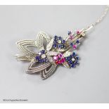 A modern white metal, ruby, sapphire and diamond set foliate spray brooch, 567mm,gross weight 11.2