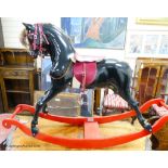 A fibre glass rocking horse, 151 cm long, 101 cm high