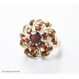 A modern 14ct gold and garnet cluster dress ring, size M/N, gross 7.4 grams