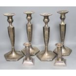 A set of 4 silver plated candlesticks and a pair of plated dwarf candlesticks