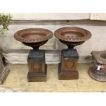 A pair of glazed stoneward garden urns on pedestals, height 79cm, diameter 51cm