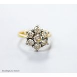 A modern 18ct gold and seven stone diamond cluster ring, size E (sizing spheres), gross weight 3.7