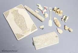 A late 19th century Chinese carved ivory card case, a similar needle case, an aide-memoire and