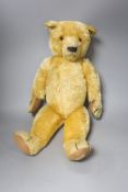 An early 20th century Chad Valley blonde plush teddy bear, length 58cm