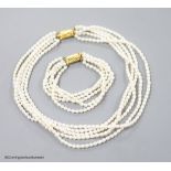 A modern multi strand cultured pearl necklace, with gilt metal clasp, 38cm and a matching bracelet,