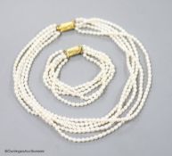 A modern multi strand cultured pearl necklace, with gilt metal clasp, 38cm and a matching bracelet,