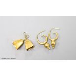 A pair of yellow metal earrings and a pair of yellow metal cowbell charms,gross 8.4 grams.