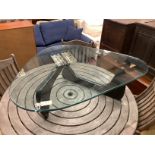 A Isamu Noguchi style coffee table,the triangular heavy glass top (approximately 2cm thick) on