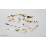 A small collection of stick pins, 'ladder and key' fob seal, bar brooches and charms etc. including