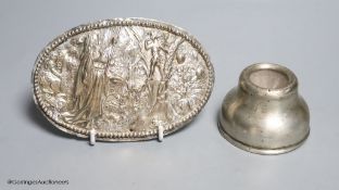 A small silver inkwell and a small plated figural plaque