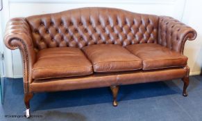 A George III style buttoned tan leather camel back sofa, 210 cm wideProvenance - a country estate