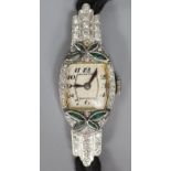 A lady's 1940's/1950's white metal (stamped platinum), emerald? and diamond set cocktail watch, on