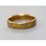 A modern 585 yellow metal wedding band, size W, 6.1 grams.