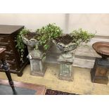 A pair of reconstituted stone garden urns on pedestals, height 97cm, width 55cm