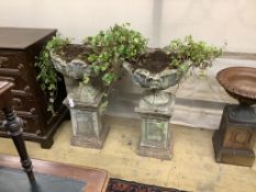 A pair of reconstituted stone garden urns on pedestals, height 97cm, width 55cm