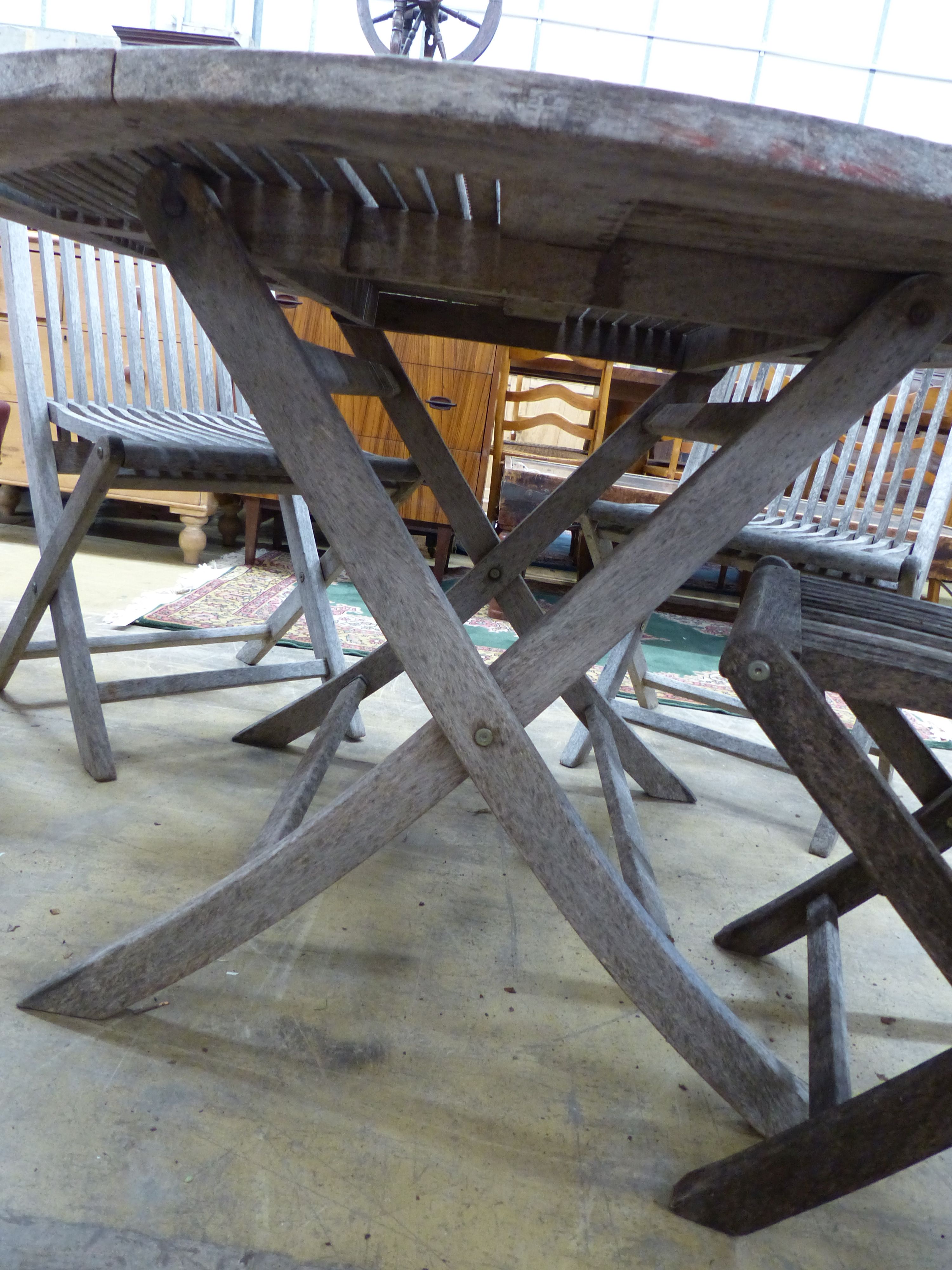 A teak garden table, 125cm diameter and four matching chairs, all folding - Image 4 of 4